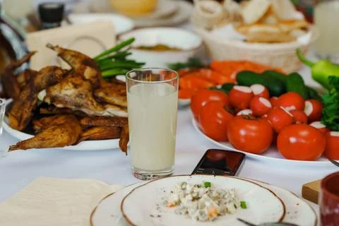 Dinner table setting with food and drinks in a home Stock Photos