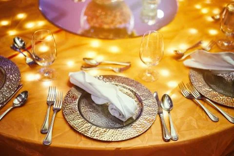 Dinner table setting with light decoration under the table Фото
