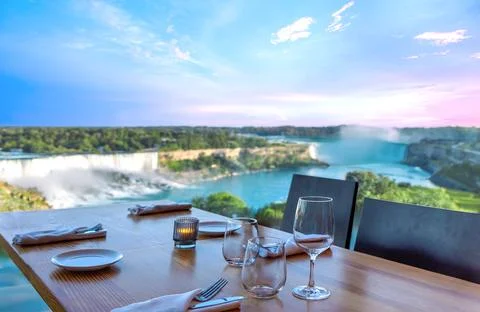 Dinner table setting with wine glasses and tableware overlooking the spectacular Stock Photos