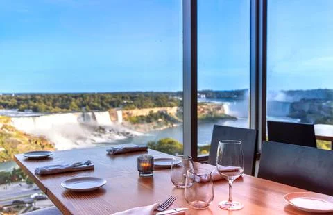 Dinner table setting with wine glasses and tableware overlooking the spectacular Stock Photos