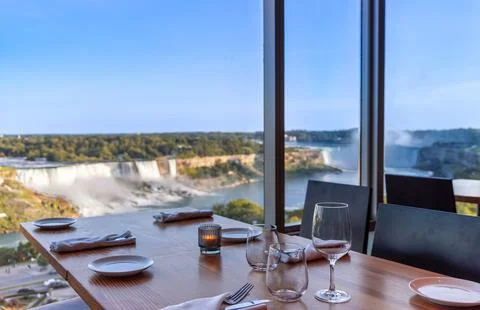 Dinner table setting with wine glasses and tableware overlooking the spectacular Stock Photos