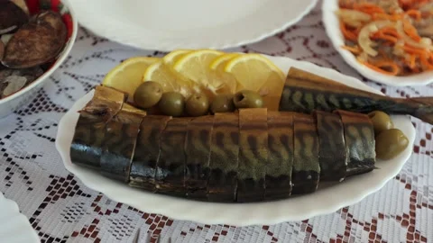 Dinner table, smoked fish, mackerel with olives and lemon, Ukrainian cuisine Stock Footage 219329564