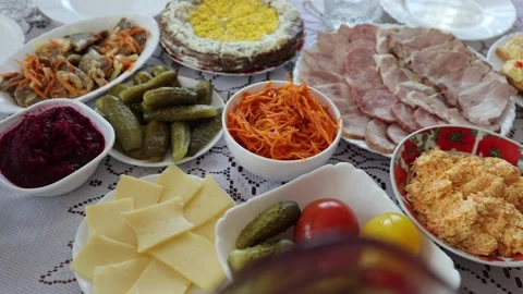 A dinner table with various dishes, Ukrainian folk dishes, salads, etc. Stock Footage 219329512