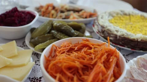 A dinner table with various dishes, Ukrainian folk dishes, salads, etc. Stock Footage 219329551