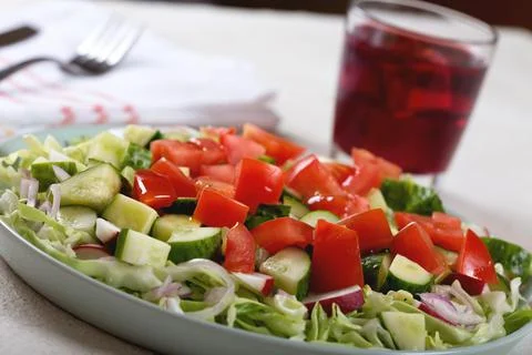 Dinner table with vegetable salad and red wine Fotos de archivo