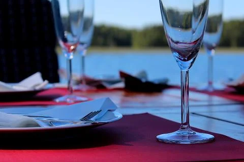 Dinner table by the water. Stock Photos
