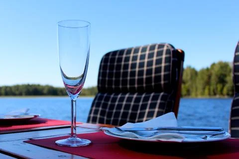 Dinner table by the water. Stock Photos