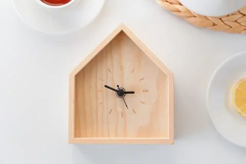 Dinner time. Wooden clock in the shape of house isolated on white background Stock Photos