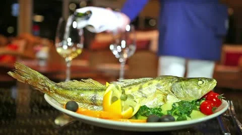 Dinner for two people with fish and wine Stock Footage 24666572