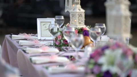 Dinner wedding decoration white table preparation hotel garden flowers close up Stock Footage 134350955
