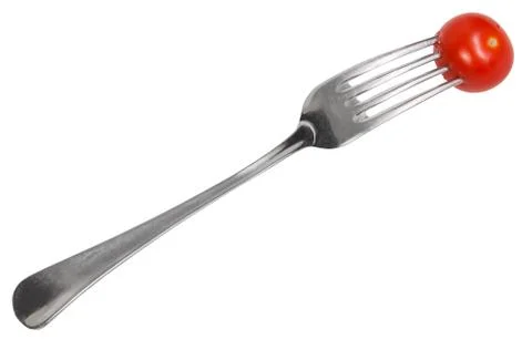 Dinning fork with impaled cherry tomato Stock Photos