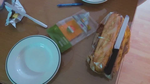 A dinning table with breakfast ready to serve, having plates, knives and Stock Footage 123883248