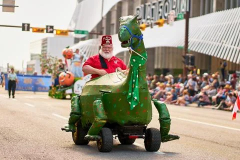 A dinosaur float rolls down the streets of Calgary during the Stampede Parade Stock Photos