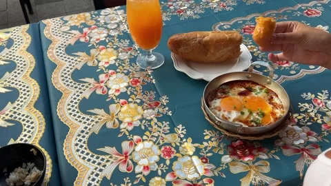 Dip bread in egg yolk hand dips bread in yolk and shows on background. Shakshuka Stock Footage 317703408