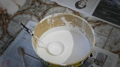 Dip the brush in the paint for walls Stock Footage 56923755