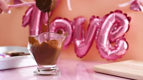 Dip cake pops in black melted chocolate and making sweet cookies . Slow motion Stock Footage 169306034