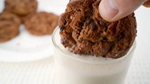 Dip the cookies in milk. Stock Footage 286244879