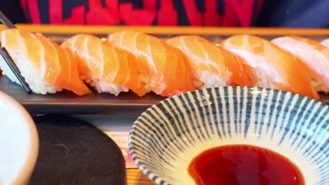 Dip sushi in soy sauce Stock Footage 296536669