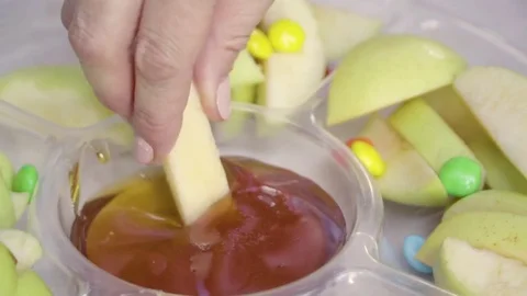 Dipping apple in honey Stock Footage