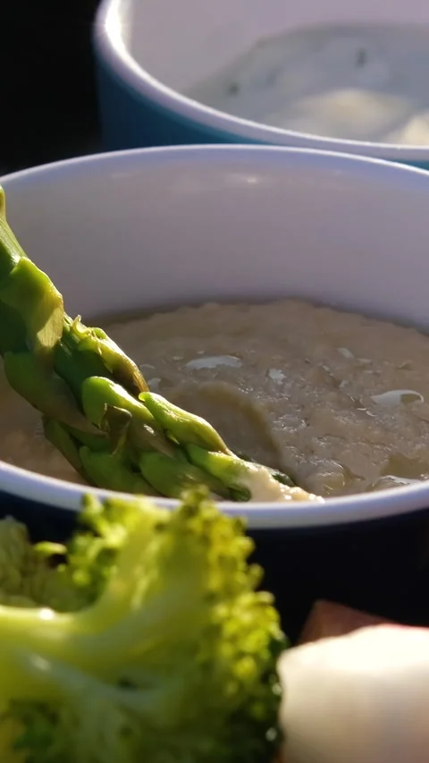 Dipping asparagus in sauce Chef preparing mixed grilled seafood platter - Stock Footage 316071509