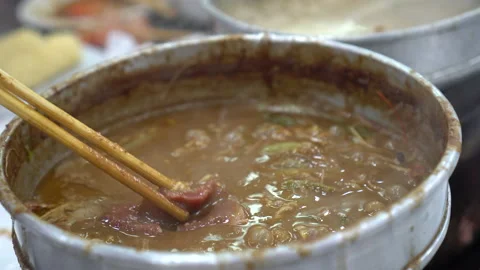 Dipping beef slice in peanut sauce satay broth base hot pot style in Hong Kon Stock Footage 159489965