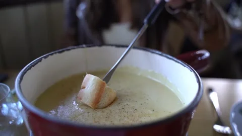Dipping bread in cheese fondue Vídeo Stock 244947067