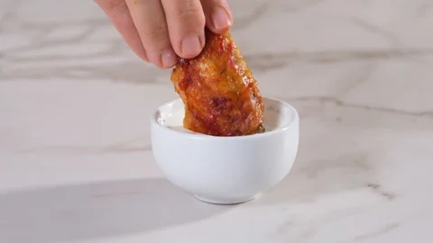Dipping buffalo wings into sauce Stock Footage 205096368