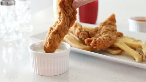 Dipping a Chicken Strip into BBQ Sauce Stock Footage