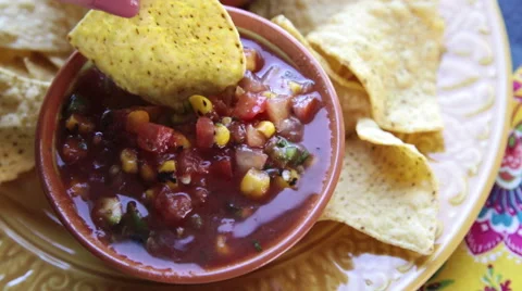 Dipping Chip into Salsa Video stock 63337180