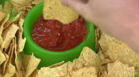 Dipping Chips into Salsa Stock-Footage 473897