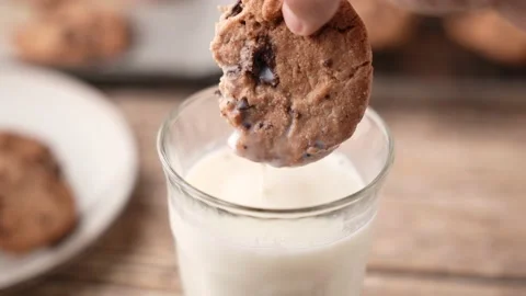 Dipping chocolate chip cookie into milk 스톡 동영상 158776397