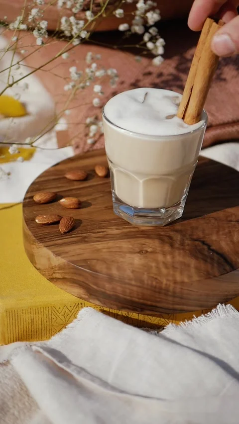 Dipping Cinnamon Roll into a Glass of Cold Coffee Stock Footage 297376511