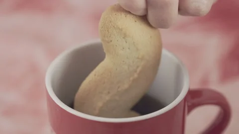 Dipping cookie into coffee cup Stock Footage 328076961