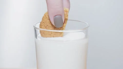 Dipping cookie into milk Video stock 231552411