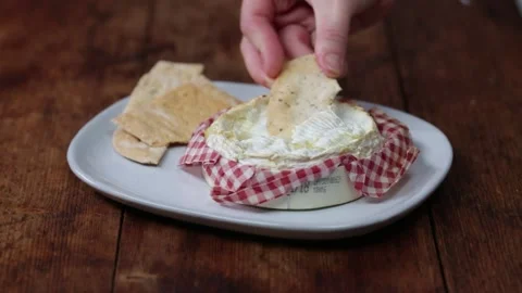 Dipping cracker in Camembert Stock Footage 166862930