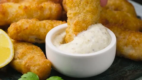 Dipping Crispy Fish strips in tartar sauce. Stock Footage 166509085