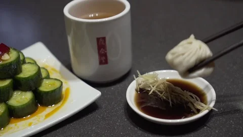 Dipping dumpling into soy sauce. Slow motion.  Video stock 78886351