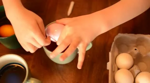 Dipping easter eggs Stock Footage 12396621