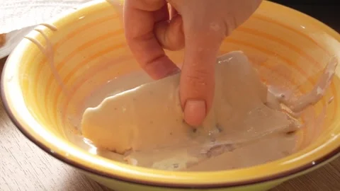 Dipping Fish Fillets in Batter. Stock Footage 258571107