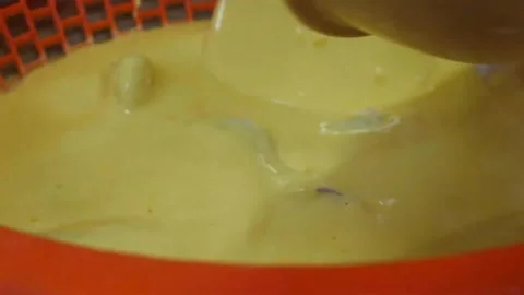 Dipping Fresh Chicken Pieces into Thick Yellow Wet Batter for Deep Frying, Cooki Stock Footage 343026877