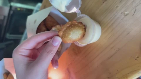 Dipping fried snack into dip white sauce on a table. Fast Food, Appetizer, Junk Stock Footage 262939588