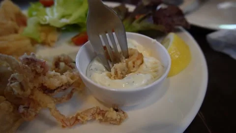 Dipping fried squid in cream sauce Stock Footage 229605680