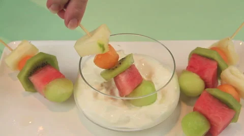 Dipping Fruit Kebabs In Yogurt Stock Footage 62016607