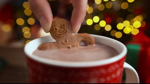 Dipping a Gingerbread Man Biscuit in a Cup of Hot Chocolate in Slow Motion Stock Footage 208932045