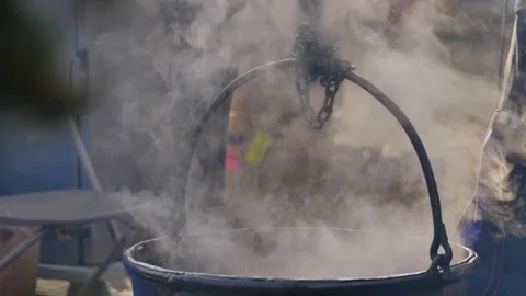 Dipping label into steaming cauldron outside fall 動画素材 121074451