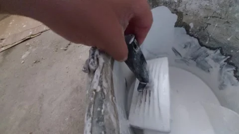 Dipping large paintbrush into a bucket filled with white wall paint, home renova Vídeo Stock 336508571