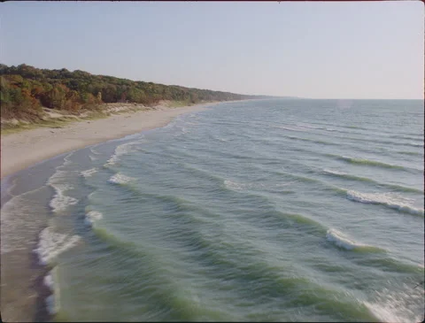 Dipping low and fast over waves along coast 1990s 35mm film Stock Footage 136384538