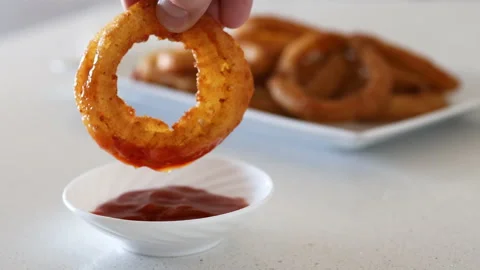 Dipping an Onion Ring in Sauce Stock Footage 137127802