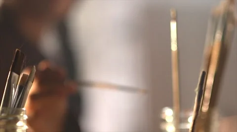 Dipping paint brush into paint Stock Footage 56237378