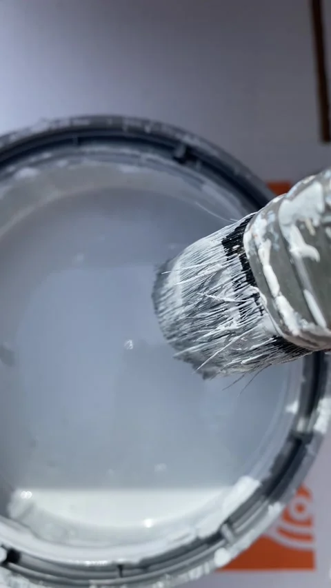 Dipping a paint brush into a tin of paint 스톡 동영상 136534517